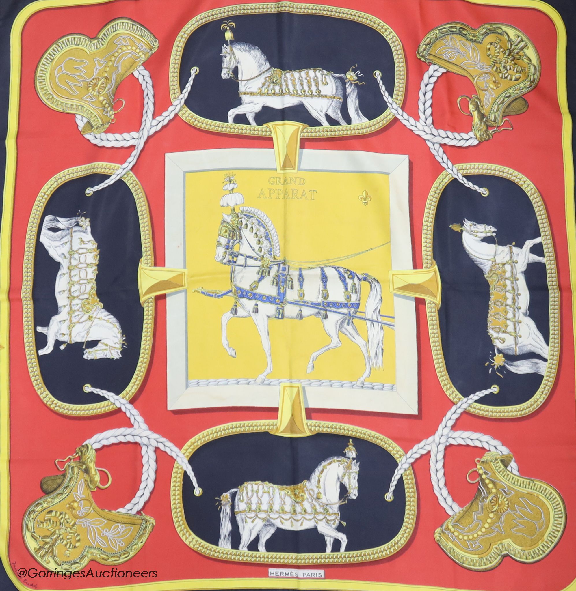 Three vintage Hermes silk scarves, 'Grand Apparat' (red, black and gold), 'En Piste' (red ground) and 'Presentation de Chevaux'